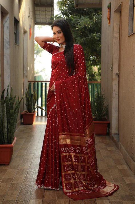 Maroon color pure hand bandhej silk saree with zari weaving work