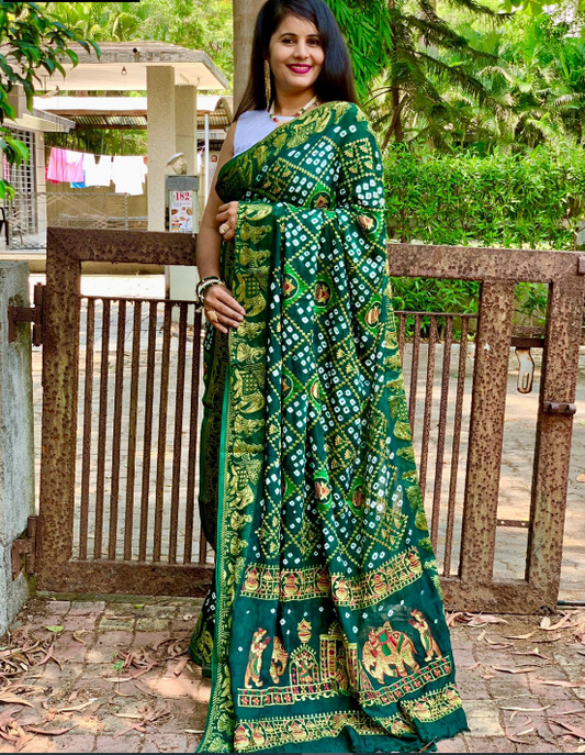 Green color pure hand bandhej silk saree with zari weaving work