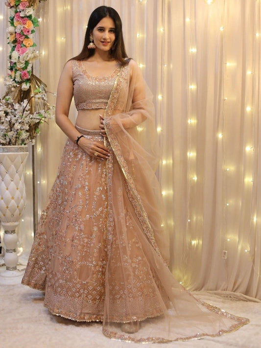 Enticing Peach Sequins Net Wedding Wear Lehenga Choli With Dupatta