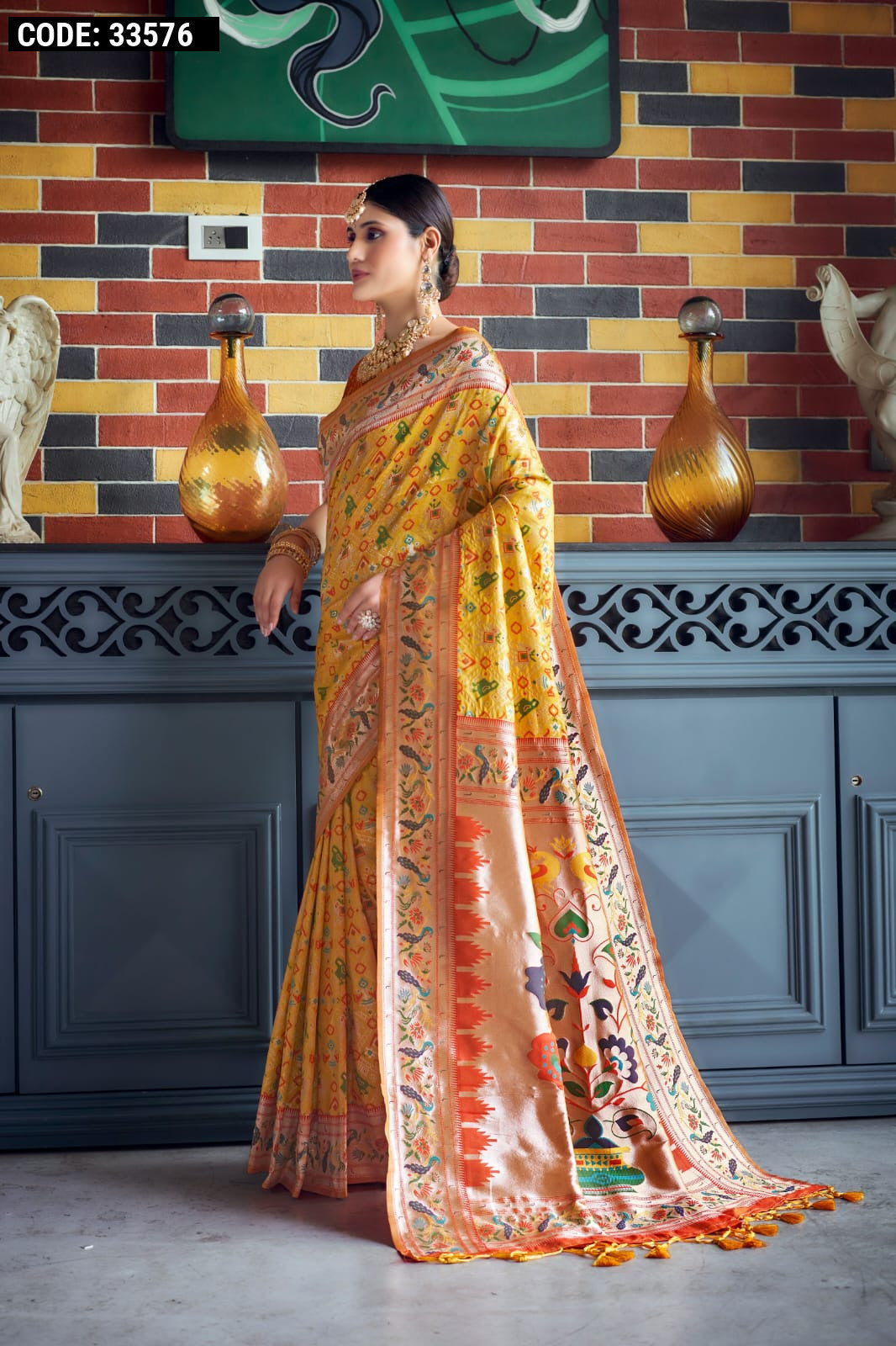 Yellow color patola silk saree with zari weaving work