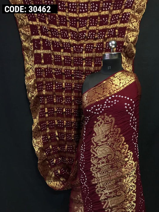 Maroon color pure hand bandhej silk saree with zari weaving work